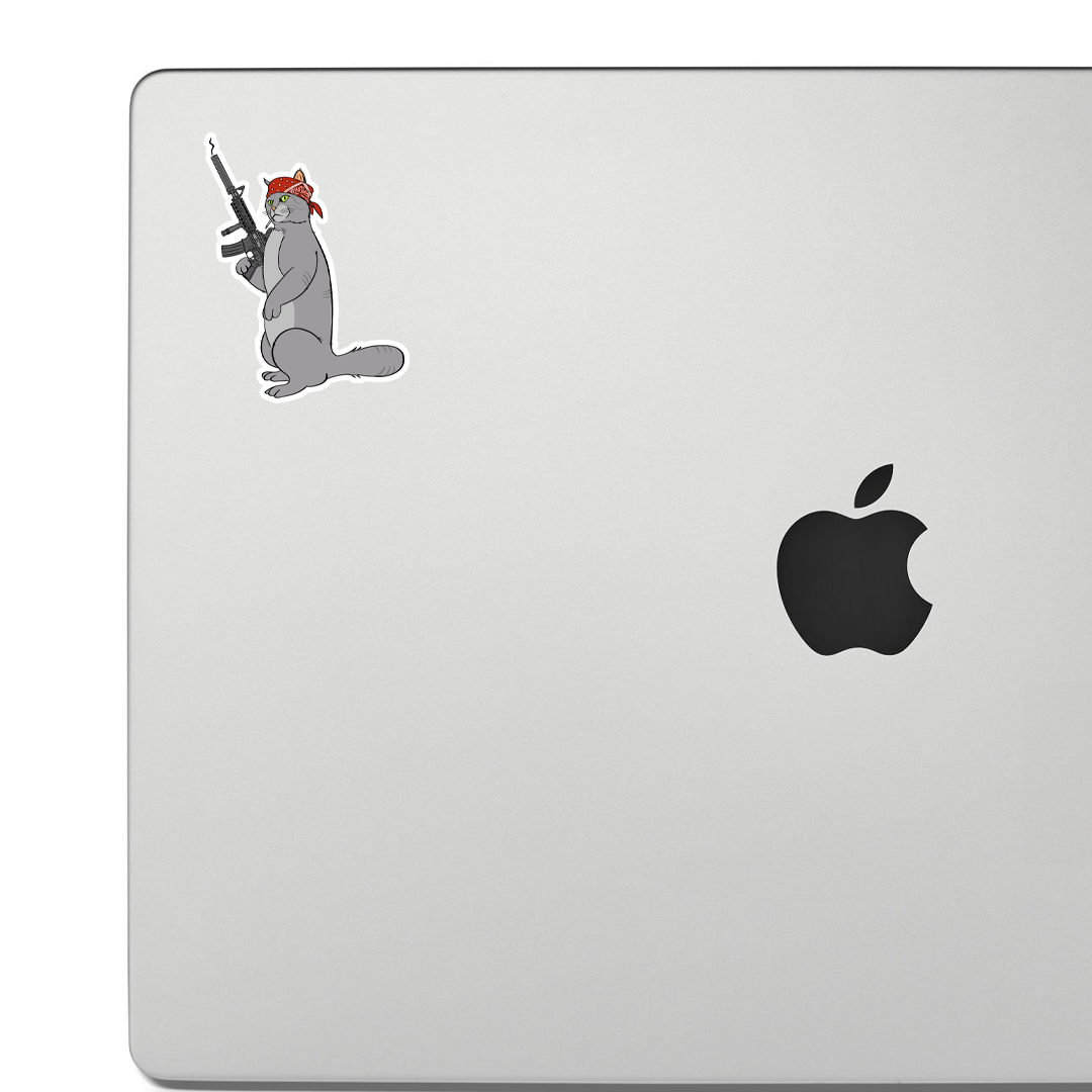 Sticker of a cat wearing a bandana and resting a large rifle on his shoulder, illustrated in a tough, cartoon style.