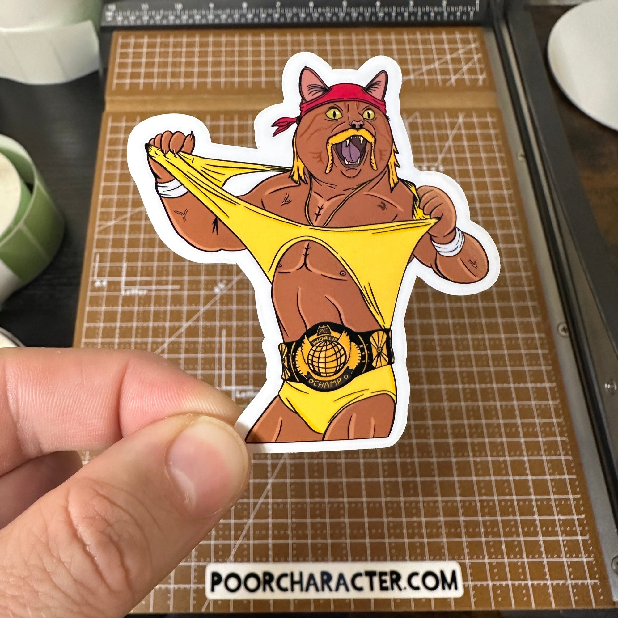 Sticker of An 80s-era pro wrestling cat tearing his t-shirt off his body and wearing the heavyweight title