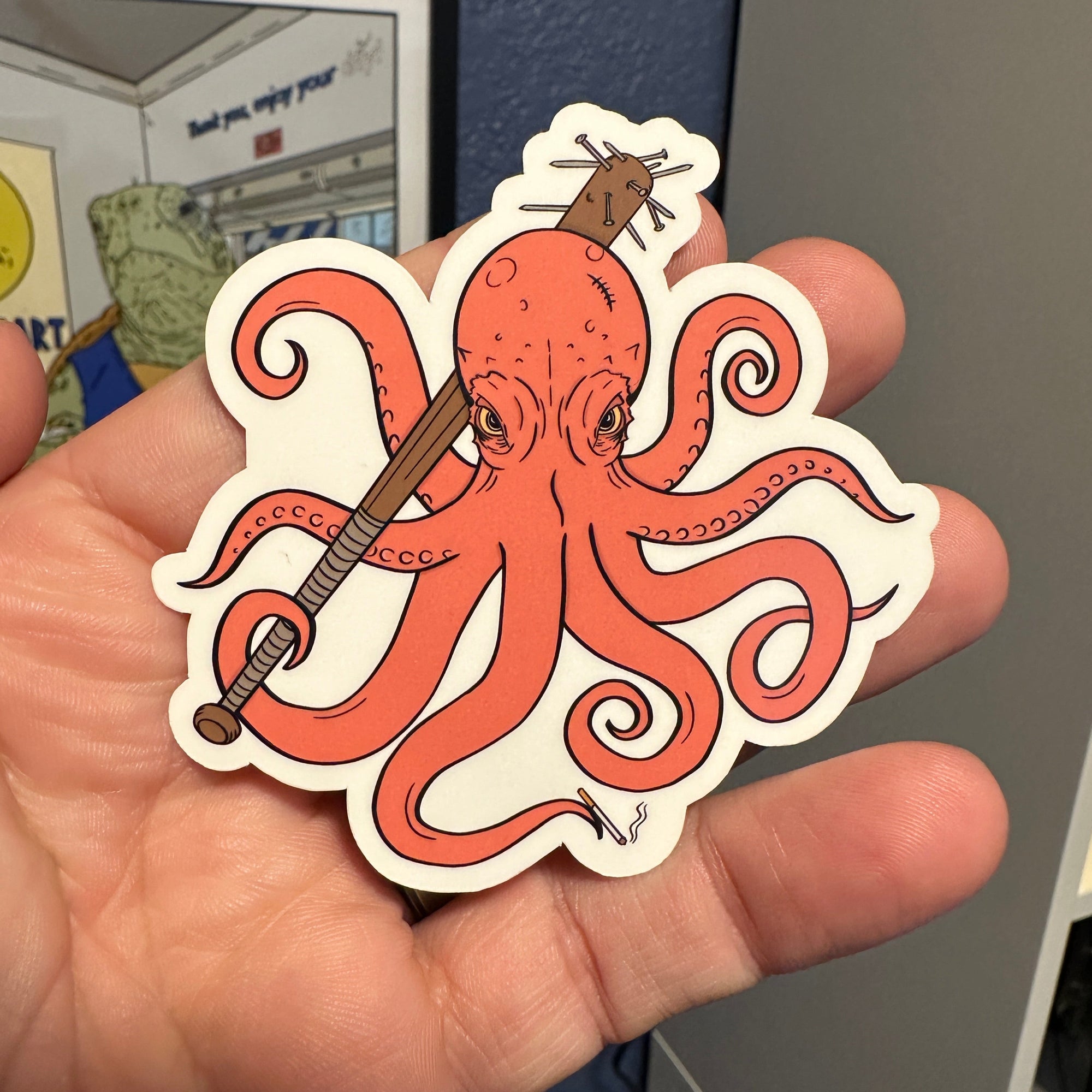 A menacing octopus holding a cigarette in one tentacle and a spike baseball bat in the other 