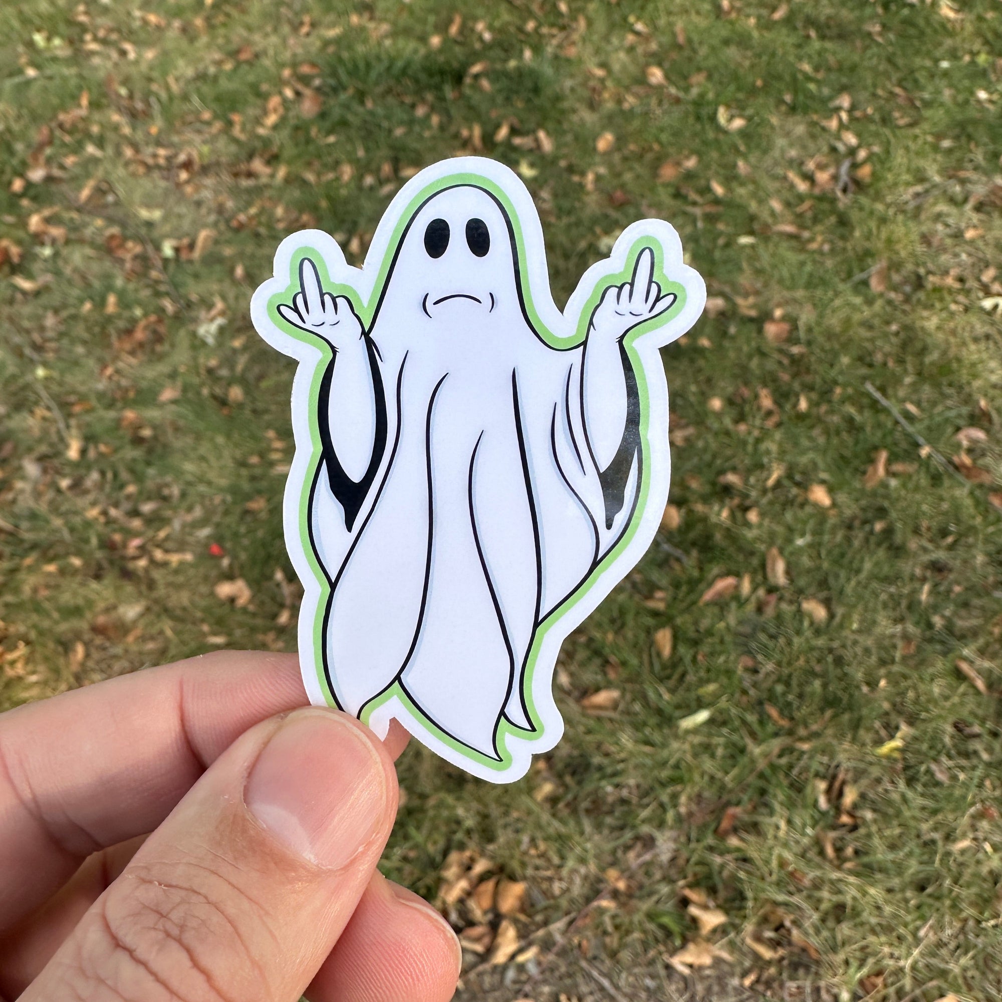Sticker of A classic white-sheeted ghost throwing up two middle fingers
