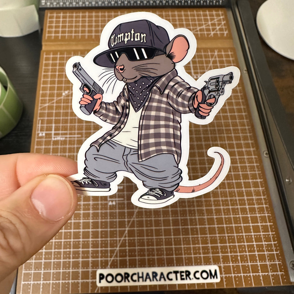 Sticker of a rat paying homage to Eazy E, holding two handguns, wearing a Compton hat and plaid shirt