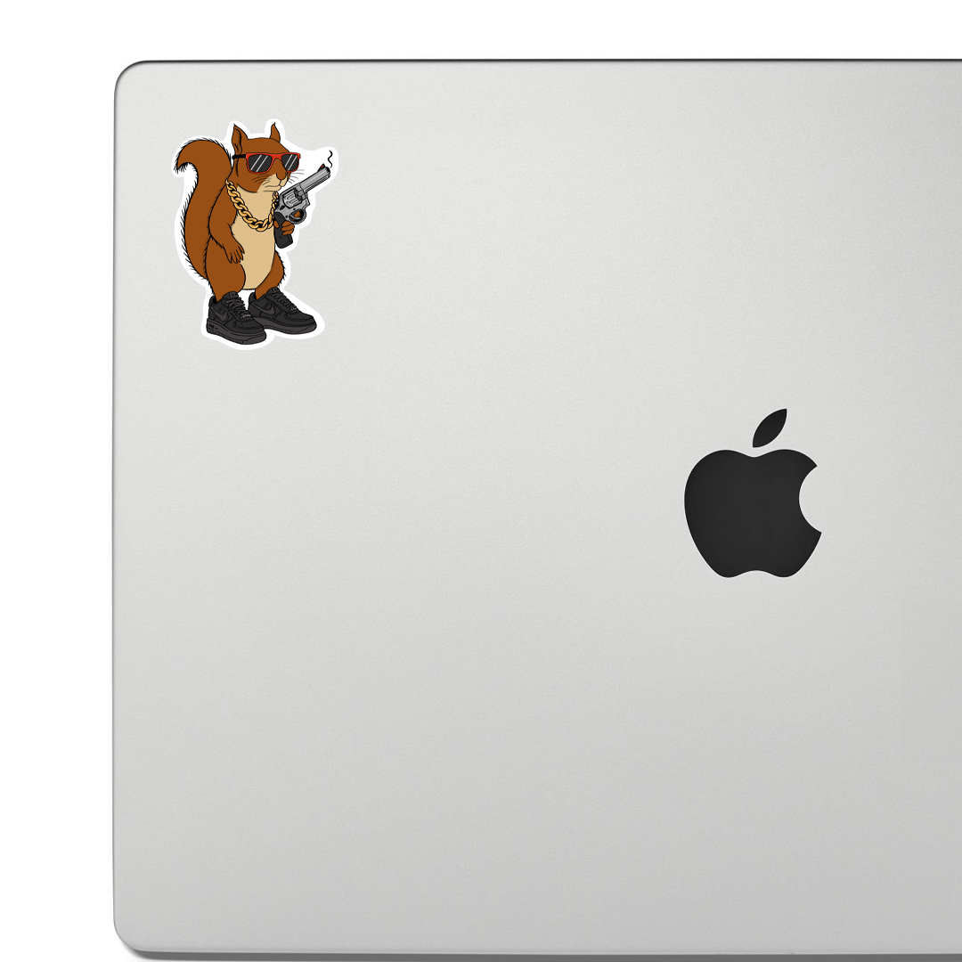 Laptop with a sticker of a cartoon squirrel holding a gun on a white background